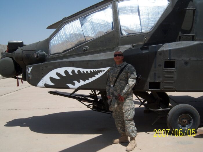 Man in military uniform in front of an aircraft