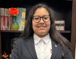 Female student in front of bookcase