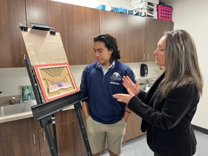 Teacher discussing a work of art with a student