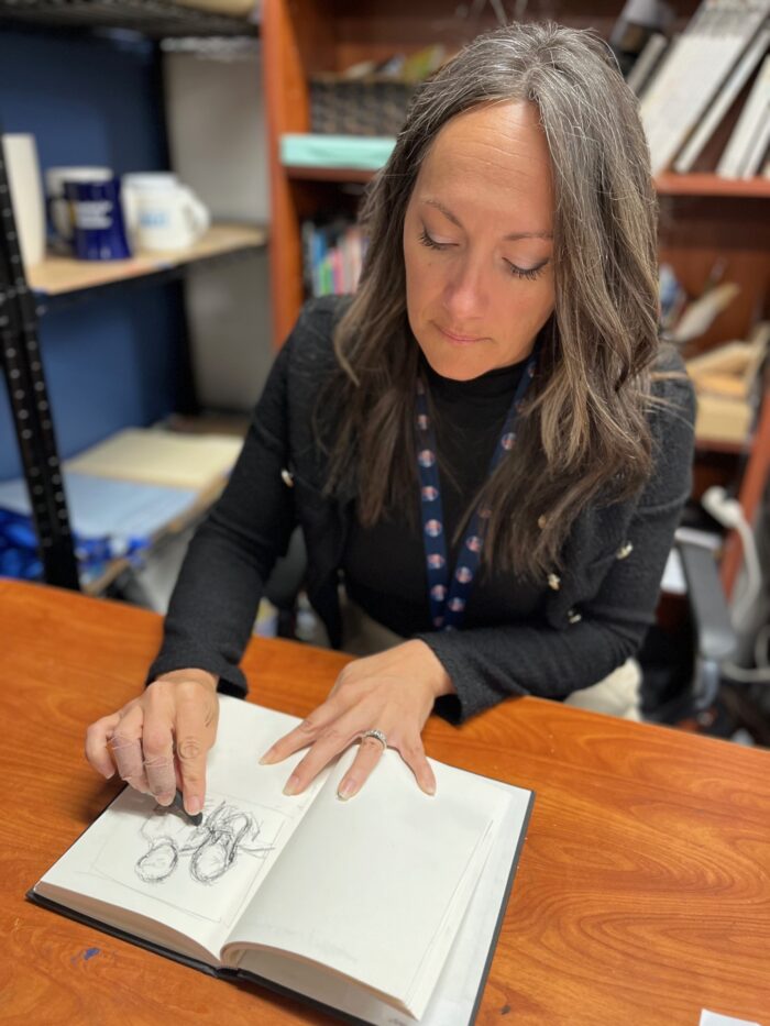 Teacher drawing in a sketchbook