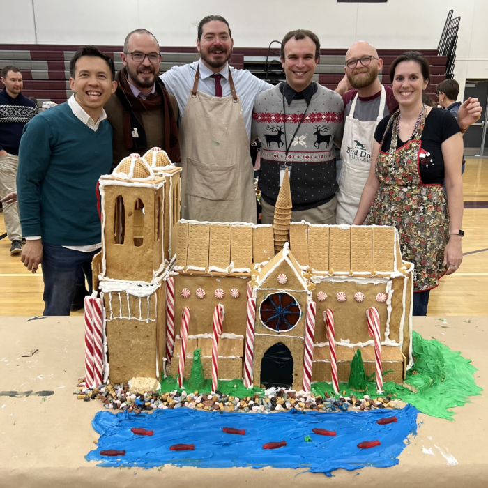 Faculty team standing with their gingerbread structure