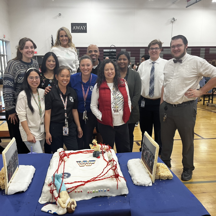 Faculty team standing with their gingerbread structure