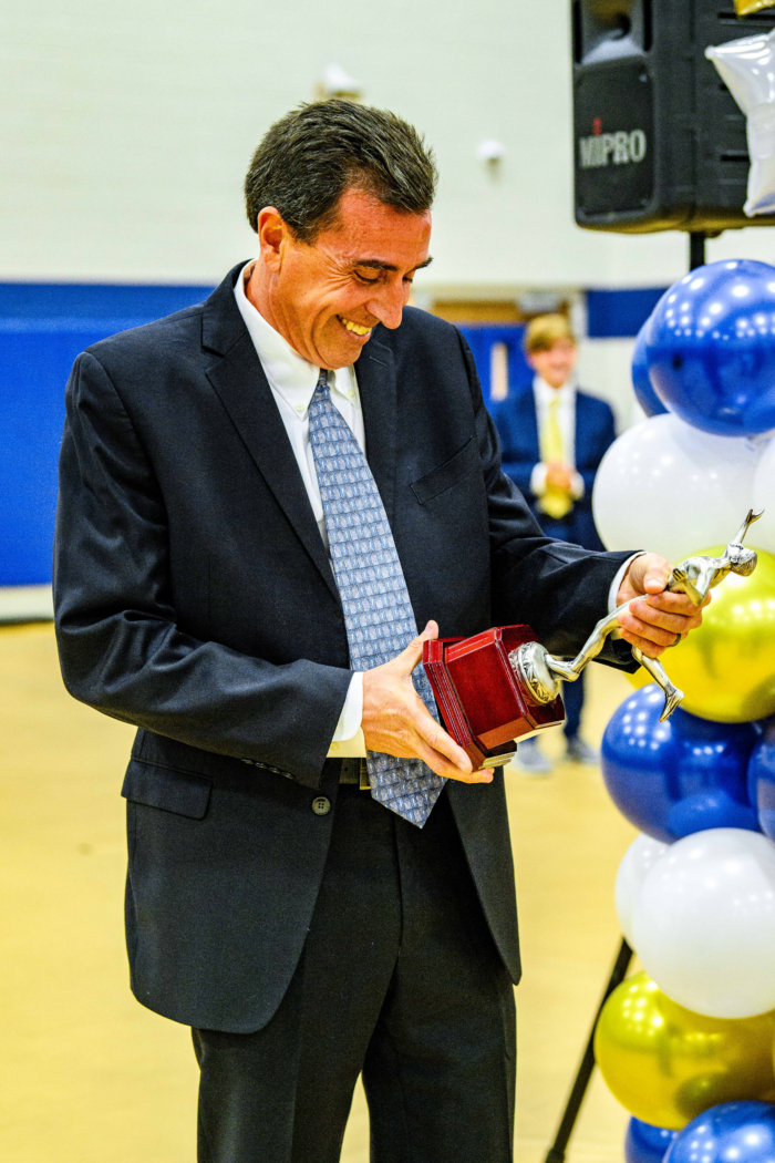 Coach Eric Webdale looking at his Coach of the Year Trophy