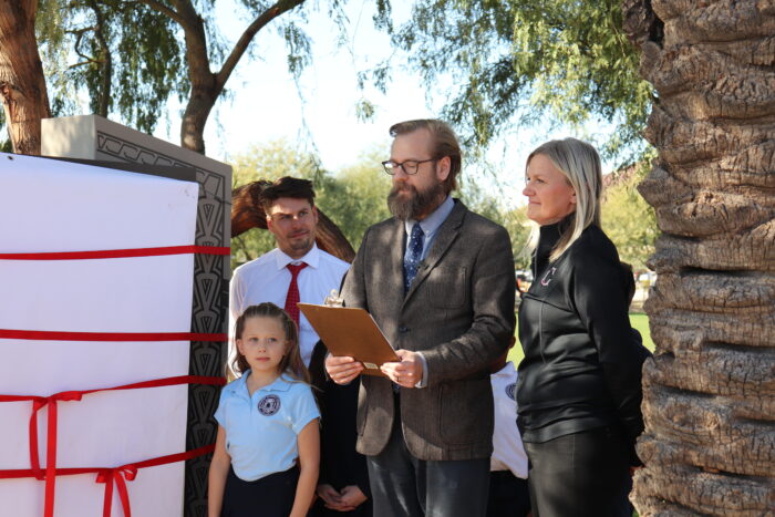 Faculty reading a poem at the unveiling of the entry sign at Cicero.