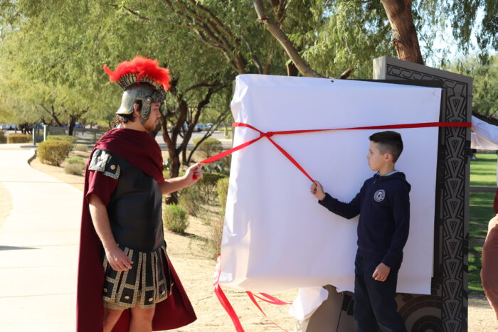 Student and mascot unveiling the entry sign at Cicero.