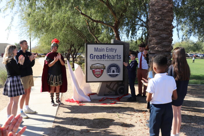 Faculty and students unveiling the entry sign at Cicero.