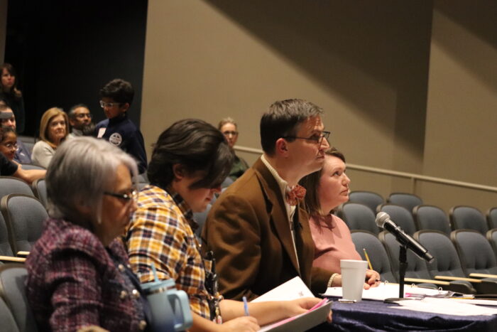 Three Spelling Bee judges at at the judging table