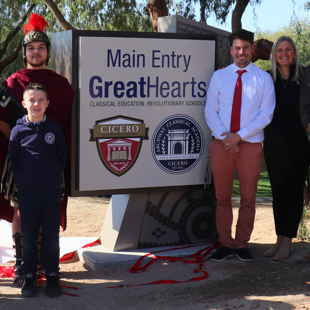 Faculty and students posing with the entry sign at Cicero.