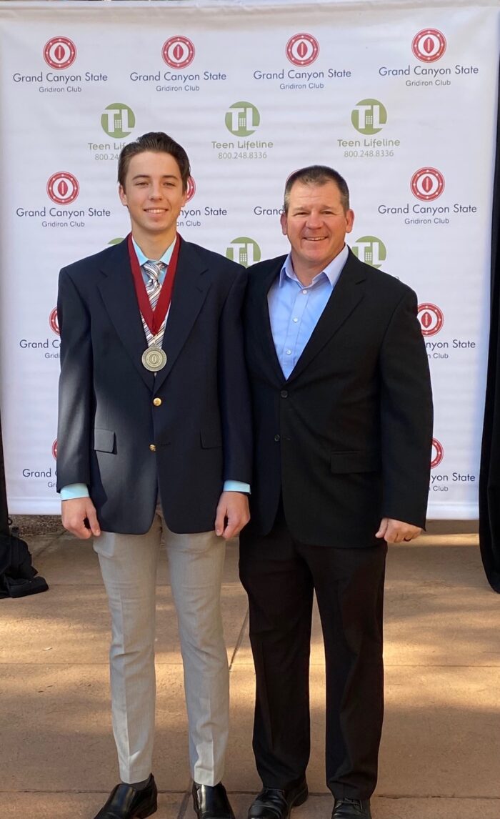 photo of Matt McClelland in high school wearing a medallion with his dad