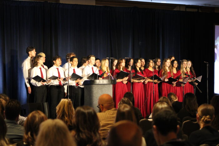 Choir performing in front of an audience.