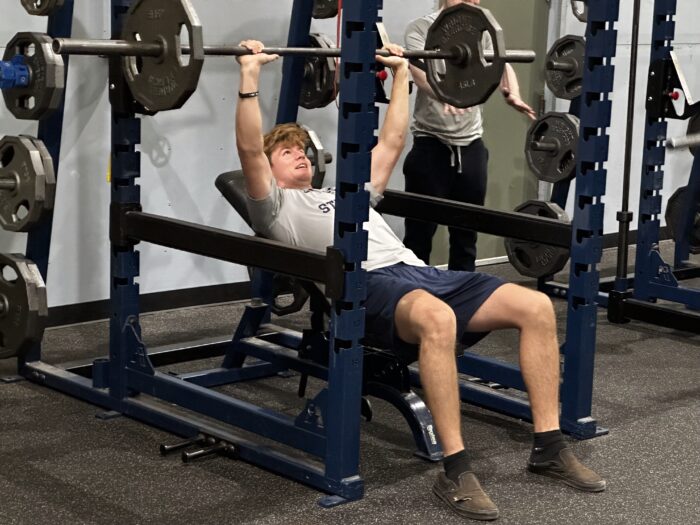 Student doing bench press