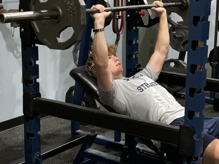 Student doing bench press