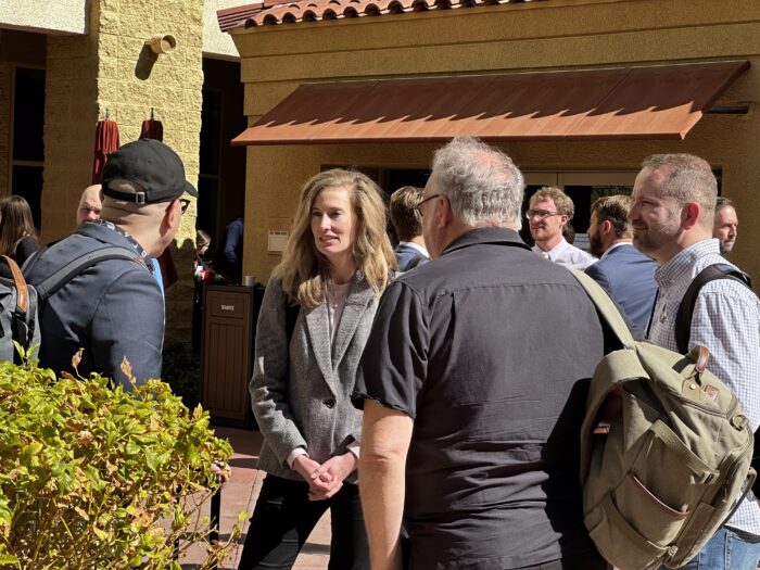 Symposiasts talking in courtyard