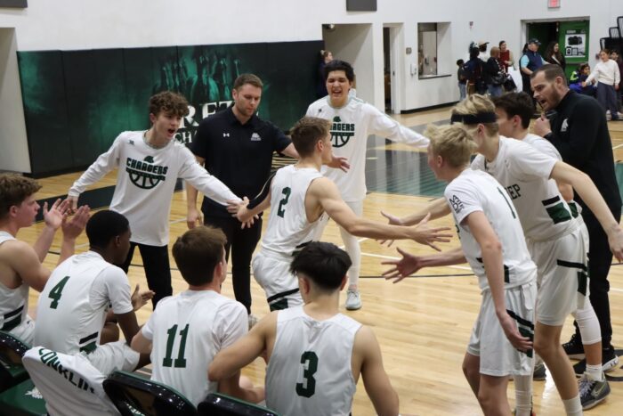 Arete athlete being congratulated by his basketball team