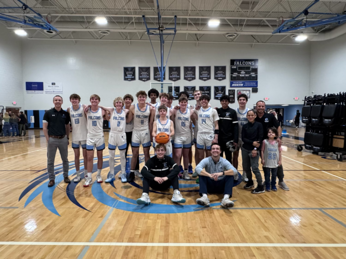 Veritas varsity boys basketball team posing for group picture in the gym