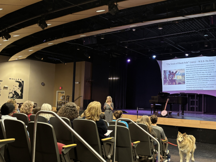 Large auditorium with speaker and an audience