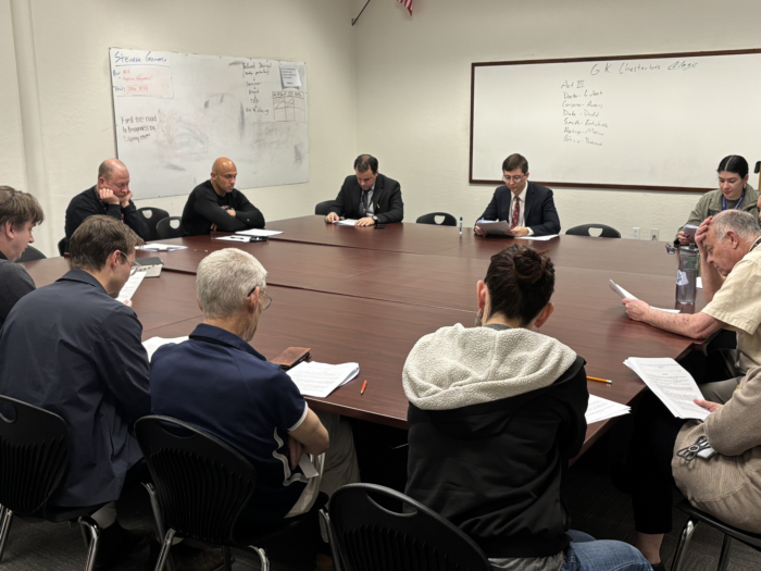 Faculty members sitting around a table