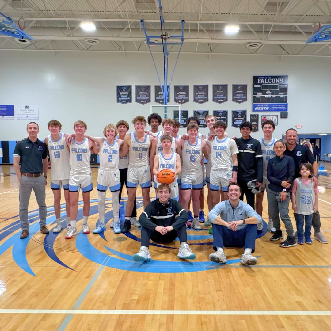 Veritas varsity boys basketball team posing for group picture in the gym