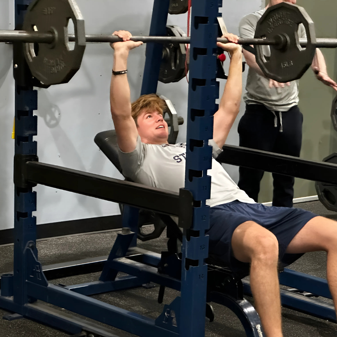 Student doing bench press