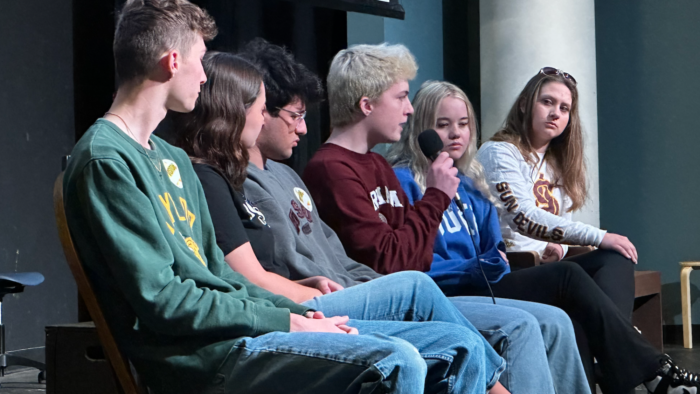 Past students speaking on a panel