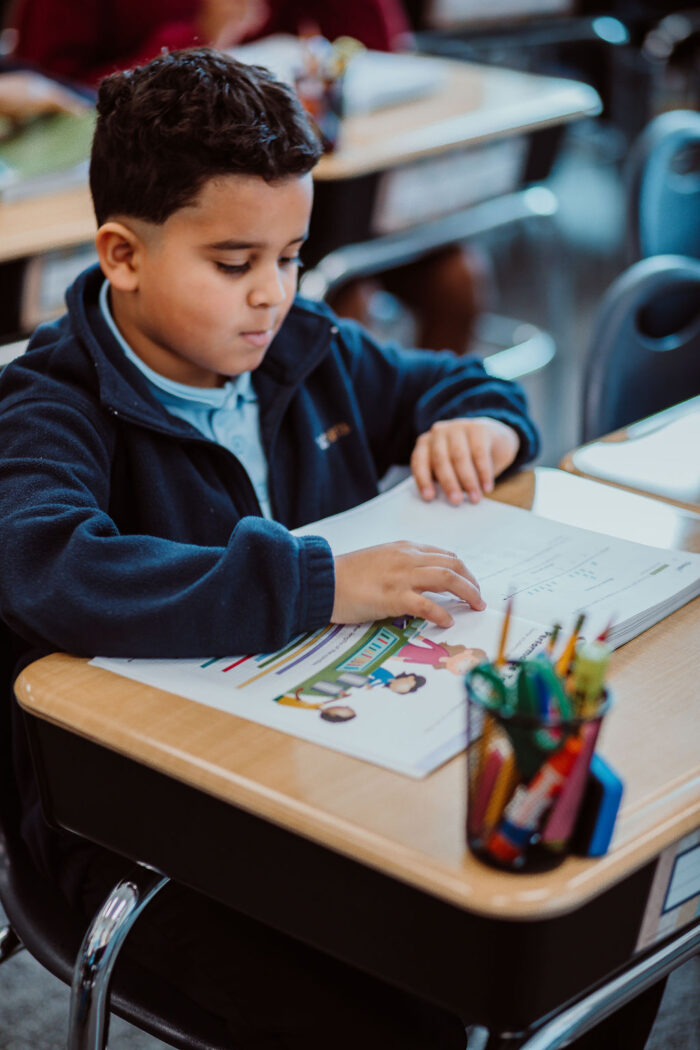 student sitting at a desk reading