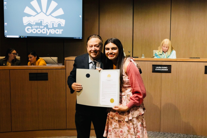 Student receiving an award from a city official