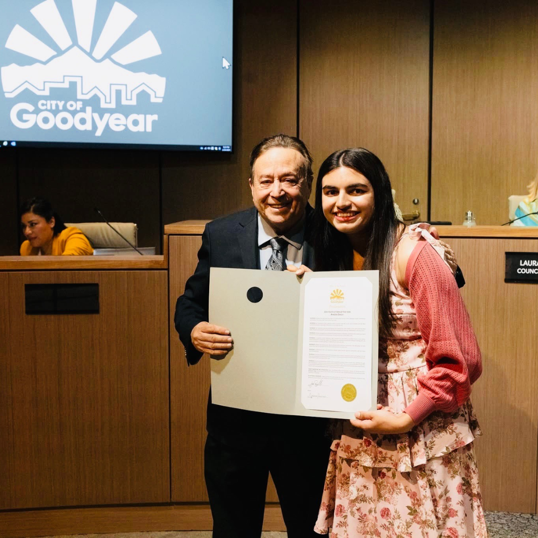 Student receiving an award from a city official