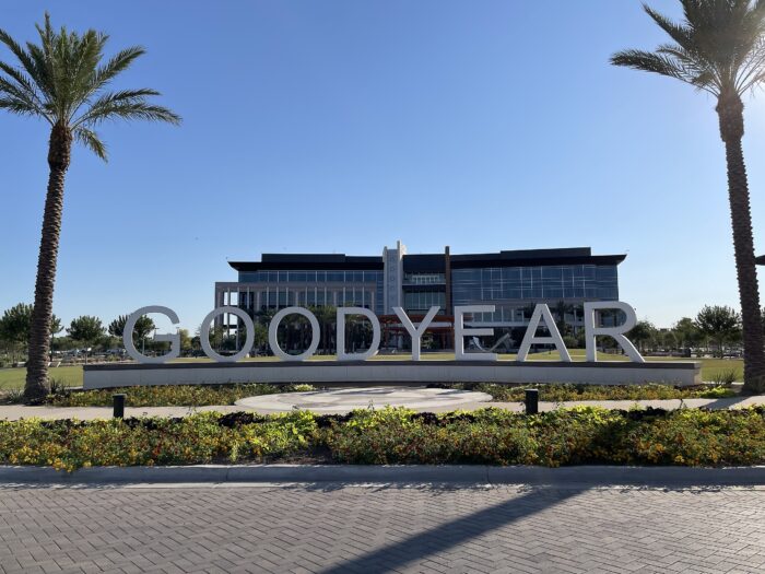 Exterior of a building with a sign that reads, "Goodyear" in front of it.