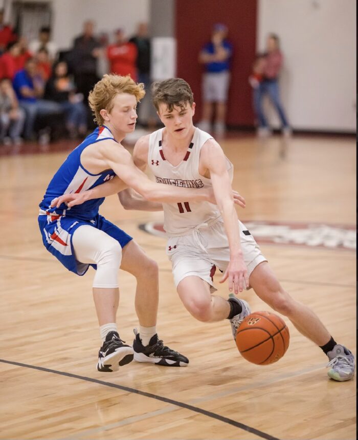 Two student athletes playing in a basketball game