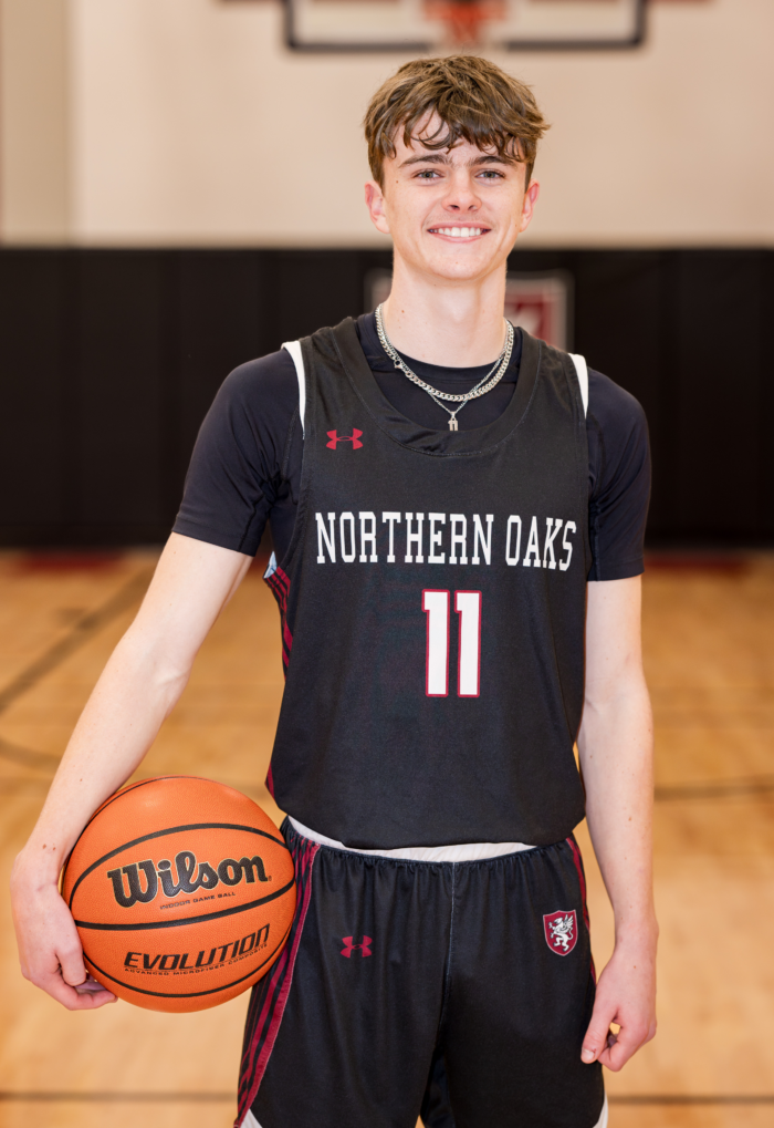 Student Athlete in basketball uniform, holding a basketball on a court